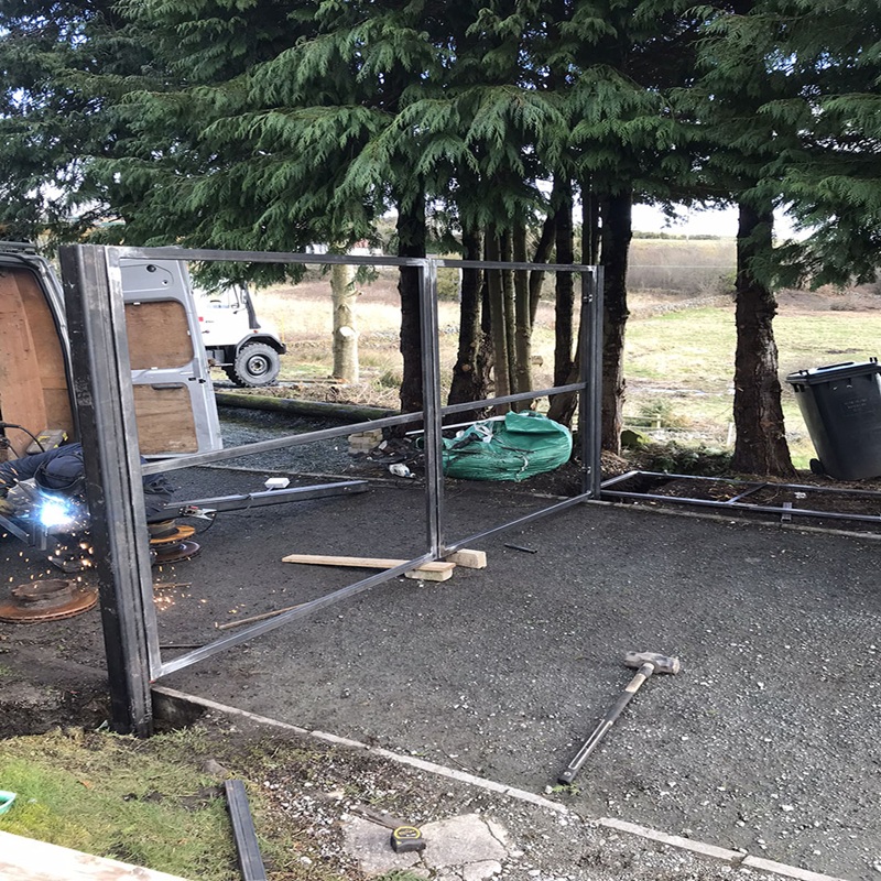 Steel gate poles anchored with rods in concrete for stability – SK Welding